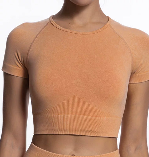 Women wearing orange sports bra for workout or fitness training.